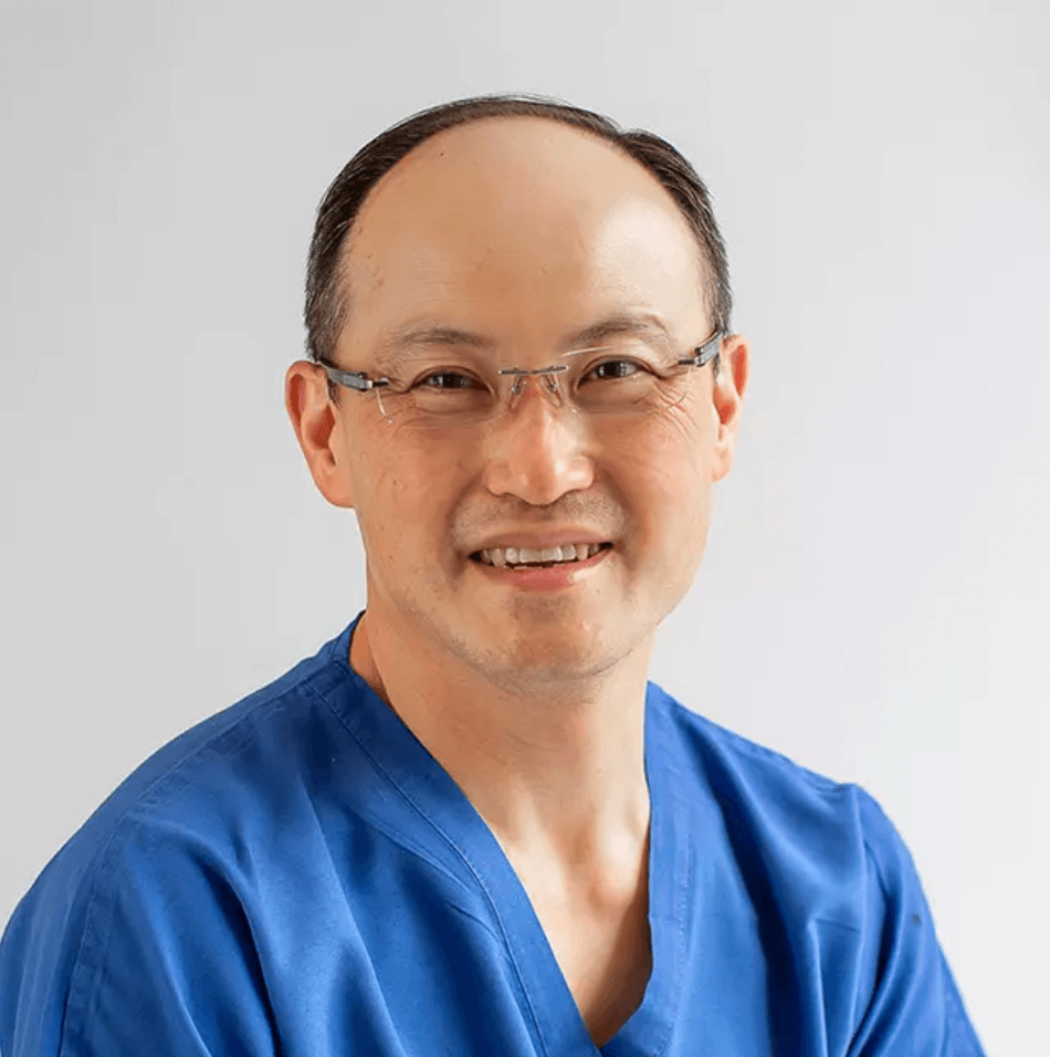 Dr. Chang Soo Kim, board-certified plastic surgeon, in surgical scrubs