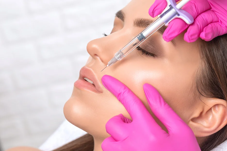 a woman undergoes lip filler procedure