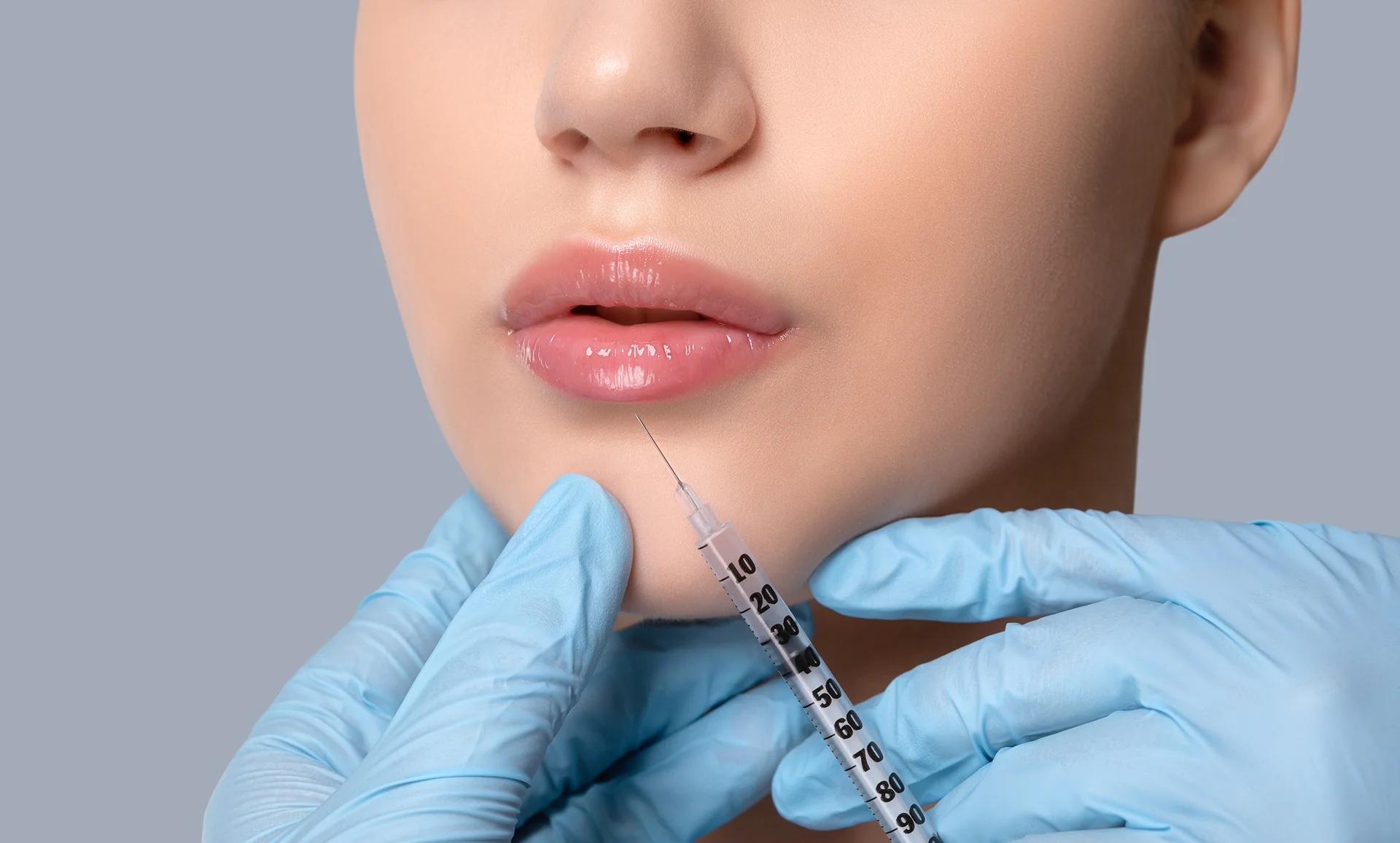 a woman receives lip filler injections|a woman with plump lips|a portrait of a relaxed