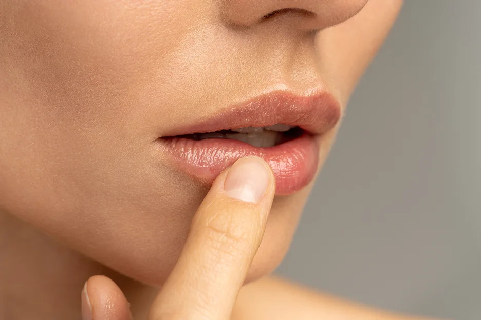a woman touches her lips