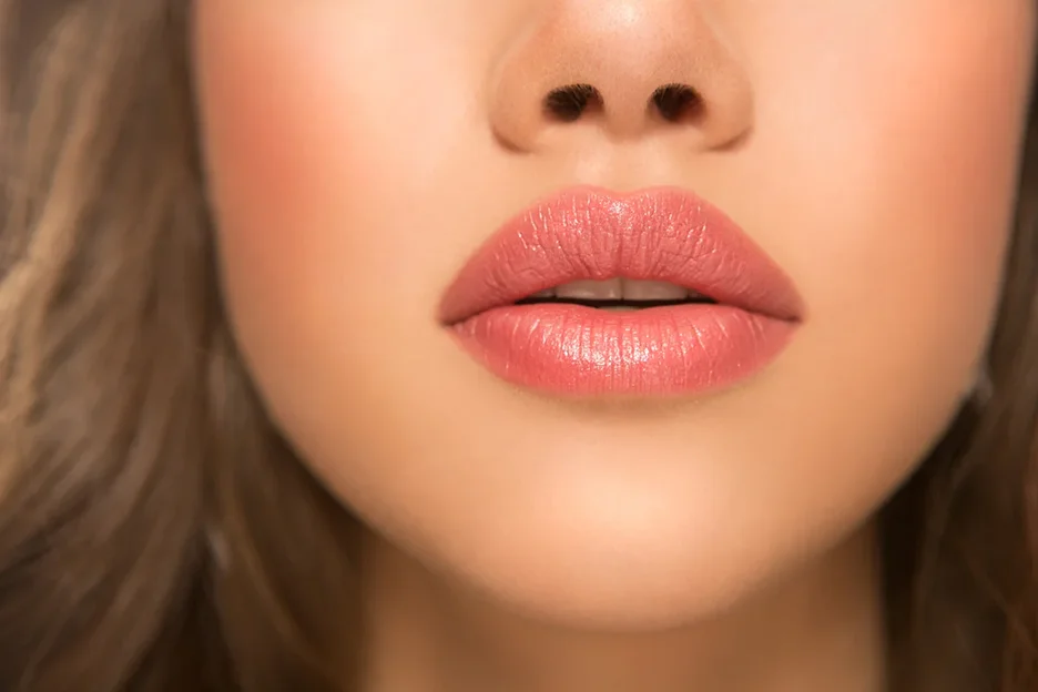 plump lips of a woman after lip filler treatment