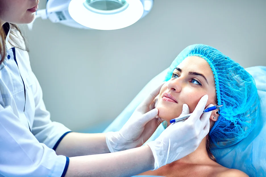 an injector examines the patient's lip anatomy for lip filler procedure