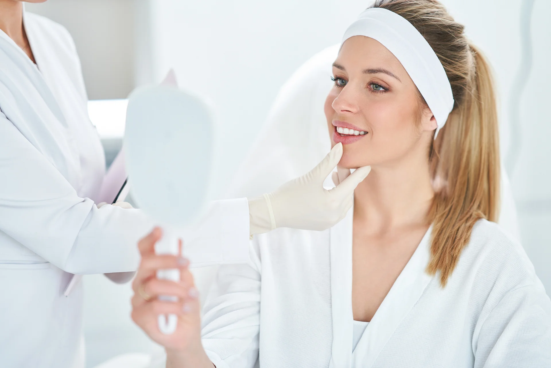 aesthetician checks the patient's lip anatomy for lip filler treatment