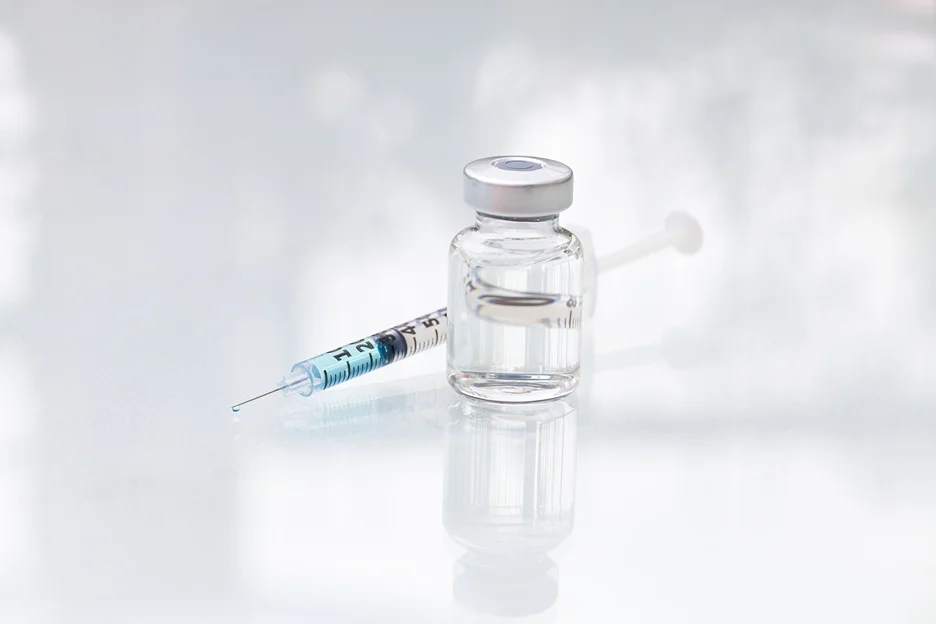 a syringe and a vial of restylane kysse lip filler