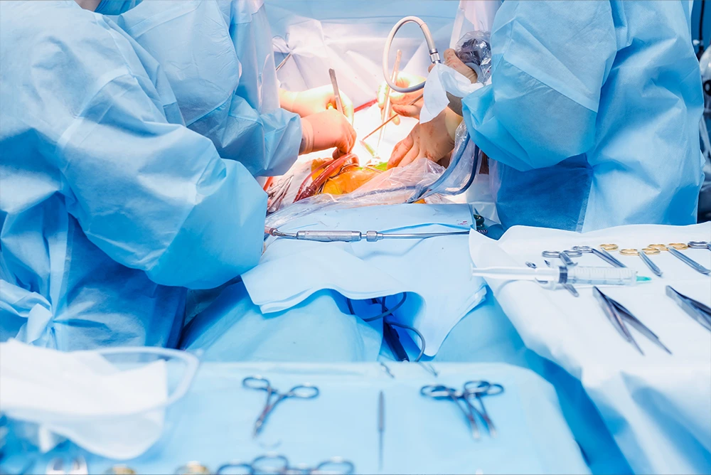 Mini Tummy Tuck: Surgeons in blue gowns performing abdominal procedure in operating room